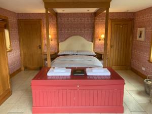 a bedroom with a bed and a red bath tub at The Green House in Glenelg