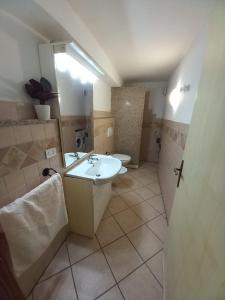 a bathroom with a sink and a toilet at Casa Roberto in Arzachena