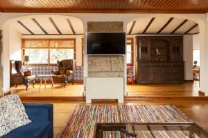 a living room with a blue couch and a fireplace at Casa da Guarda de Fora in Paredes