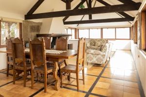 a dining room with a wooden table and chairs at Casa da Guarda de Fora in Paredes