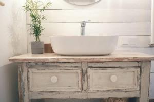 a bathroom vanity with a sink on top of it at Hand made Off Grid forest Cabin Luna 