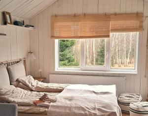 a bedroom with two beds and two windows at Hand made Off Grid forest Cabin Luna 