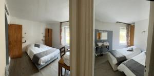 a bedroom with two beds and a desk and a mirror at Logis De La Grande Cascade in Le Tholy