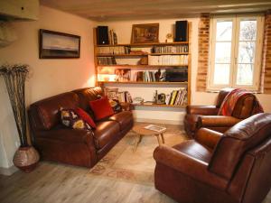 a living room with two leather couches and a table at Gîte Parassy, 2 pièces, 2 personnes - FR-1-586-31 