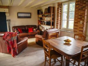 a living room with a couch and a table at Gîte Parassy, 2 pièces, 2 personnes - FR-1-586-31 