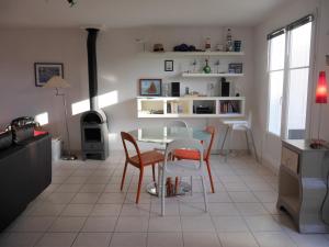 a kitchen with a table and chairs in a room at Maison Sauzon, 3 pièces, 4 personnes - FR-1-418-212 in Sauzon