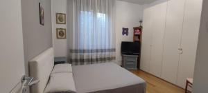 a small bedroom with a bed and a television at Affittacamere da Alina in Argelato
