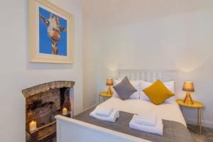 a bedroom with a bed with a fireplace at Newly Refurbished Traditional Cottage Blackrock in Blackrock