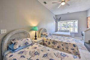a bedroom with two beds and a ceiling fan at Cozy Family-Friendly Home Near Historic District! in Savannah