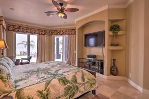 a bedroom with a bed and a flat screen tv at Riverfront Titusville Resort Home with Infinity Pool in Titusville
