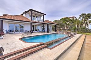 a swimming pool in the backyard of a house at Riverfront Titusville Resort Home with Infinity Pool in Titusville
