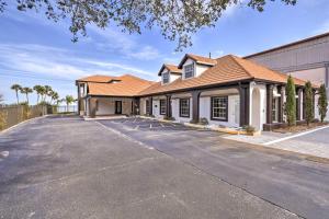 an empty parking lot in front of a building at Riverfront Titusville Home with Pool and Pickleball! in Titusville