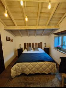 a bedroom with a large bed in a room with wooden ceilings at Casa Lisa Guest rooms in Bibbiena