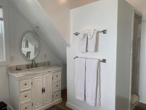 a bathroom with a sink and a mirror and towels at Agate Cove Inn in Mendocino
