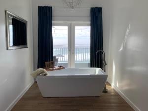 a white bath tub in a bathroom with a window at Agate Cove Inn in Mendocino