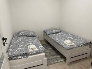 two beds sitting next to each other in a bedroom at Apartament Brzóza Królewska in Brzóza Królewska