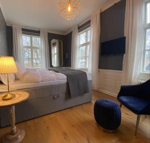 a bedroom with a bed and a table and a chair at Kinna Bed & Breakfast in Kinna