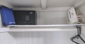 a microwave sitting on a shelf in a room at Garden Studio Flat Mango Walk in Montego Bay