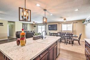 a kitchen and living room with a sink and a table at Lake Havasu Home with Pool, Near London Bridge! in Lake Havasu City