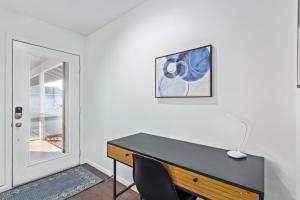 a desk in a room next to a door at Manhatton Tempe home in Tempe