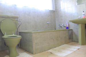 a bathroom with a toilet and a sink at El Rose Guest House in Rustenburg +14 photos