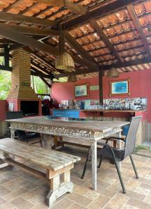 a large wooden table and benches in a restaurant at Aldeia de Camburi in Camburi
