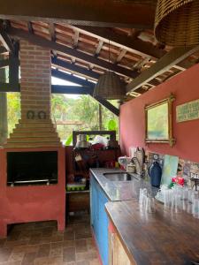 a kitchen with a counter and a sink and a stove at Aldeia de Camburi in Camburi