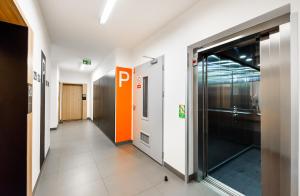 a hallway of an office with a door and a window at Metro Bemowo Colourful Apartment in Warsaw