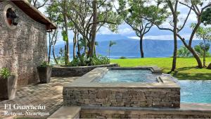 a hot tub in a stone wall next to a building at El Guayacán in Valle la Laguna