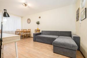a living room with a couch and a table at Lauteri Apart INN Free parking Self Check-In 24h in Tallinn