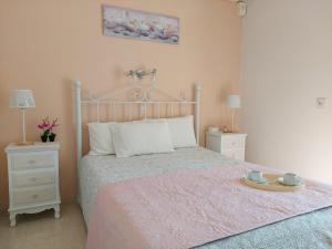 a bedroom with a bed with a tray on it at Panayota Apartments in Kassiopi