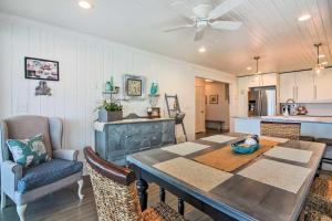 a dining room with a table and a kitchen at Sunset Cottage on Paukie Island with Private Dock! in Beaufort