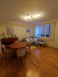 a living room with a couch and a table at Apartment inklusive Parkplatz in Velden am Wörthersee