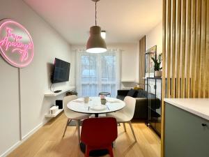 a kitchen and living room with a table and chairs at Torpo Apartment with parking in Toruń
