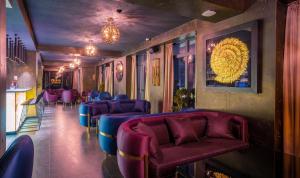 a waiting room with purple chairs and a bar at Onyx City Center in Tbilisi City