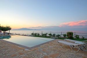 a villa with a pool and a view of the ocean at Omega Estate Resorts in Kypseli