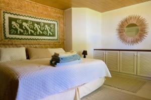 a bedroom with a bed with a pile of towels on it at Villa Ohana - Deluxe Villa w Private Beachfront in Otumai