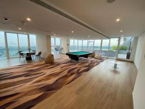 a room with a pool table in a room with windows at Feel home ! Away from home in Dubai
