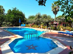 a large swimming pool with a star in the middle at Maros Spitaki in Varípetron