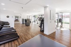 a gym with treadmills and exercise equipment in a building at Luxurious Comfy Penthouse - Steps to East Croydon Train Station - Views in Croydon