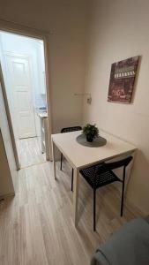 Pokój ze stołem, 2 krzesłami i drzwiami w obiekcie Kallion helmi w Helsinkach