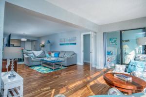 a living room with two couches and a table at Harbor Tower Intracoastal Condo in Siesta Key