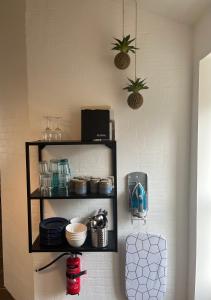 a shelf on a wall with dishes on it at Hartel House in Ollerup