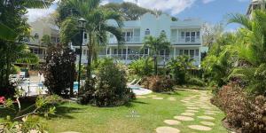 a large house with a garden in front of it at 25 Margate Gardens in Bridgetown