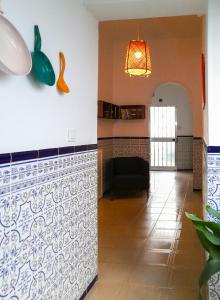 a kitchen and a living room with a couch at Casa Miraflores in Seville