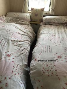 dos camas sentadas una al lado de la otra en un dormitorio en Bobbys Bolthole2, en Heysham