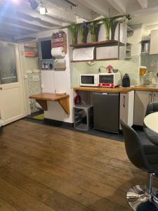 a room with a kitchen with a counter and a table at STUDIO CANAL SAINT MARTIN in Paris