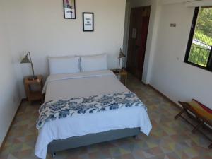 Postel nebo postele na pokoji v ubytování Hotel Casa Portones