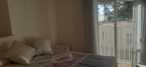 a bedroom with a bed and a large window at Apartamento a 10 metros del mar in Cullera