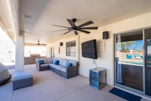 a living room with a couch and a flat screen tv at Havasu lake house 4 BR & 3 BA w/pool & hot tub in Lake Havasu City